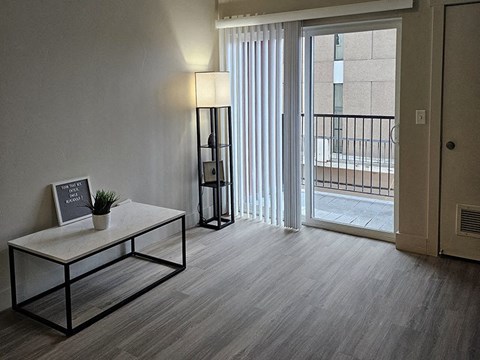 a living room with a sliding glass door and a table